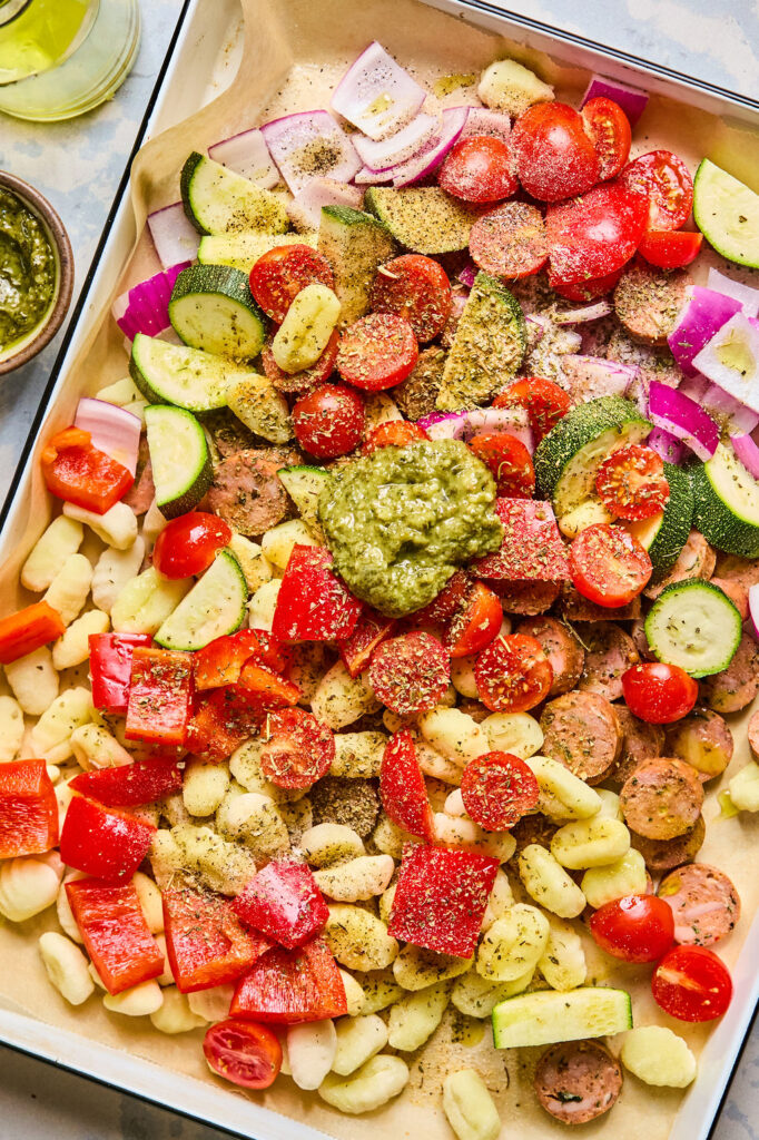 Ingredients for Sheet Pan Chicken Sausage & Veggie Gnocchi on a sheet pan.