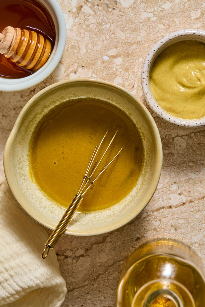 Ingredients for honey mustard mixture in a small bowl.