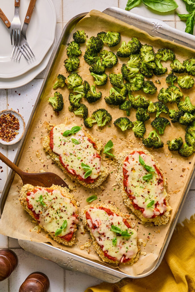 Sheet Pan Chicken Parmesan and Broccoli on a sheet pan after being baked.