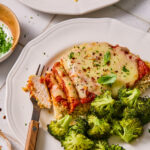 Sheet Pan Chicken Parmesan and Broccoli served on a plate.