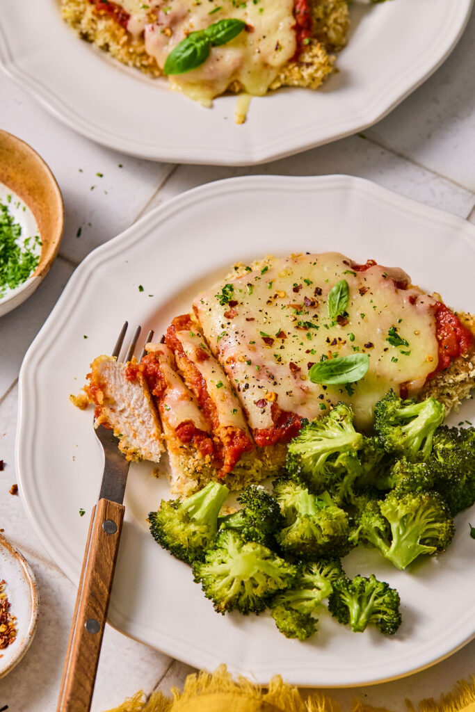 Sheet Pan Chicken Parmesan and Broccoli served on a plate.
