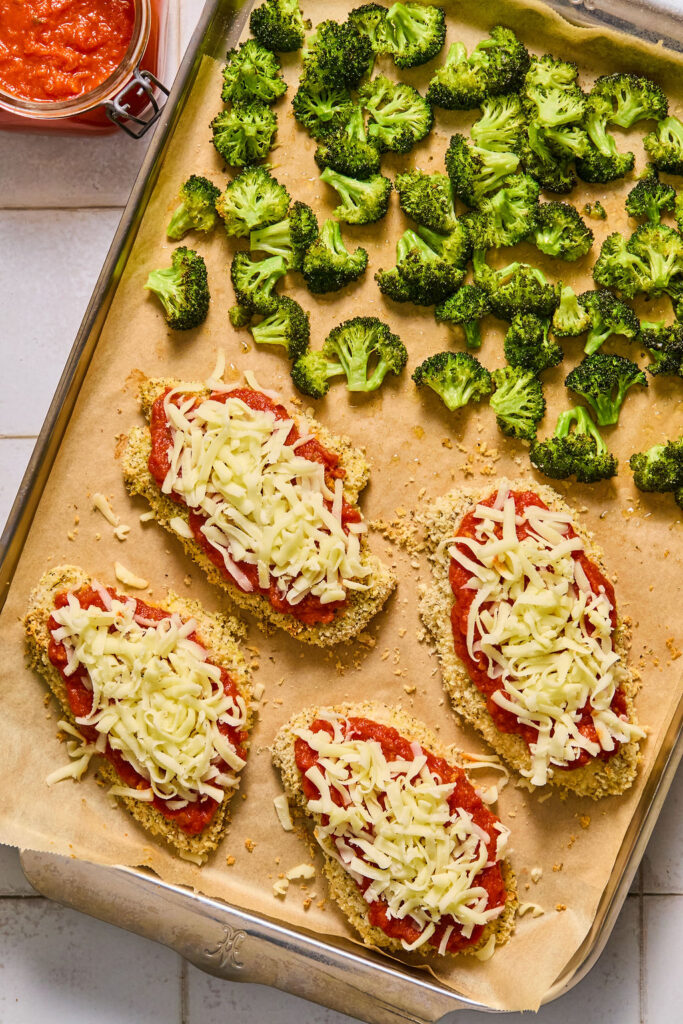 Sheet Pan Chicken Parmesan and Broccoli on a sheet pan before being baked.