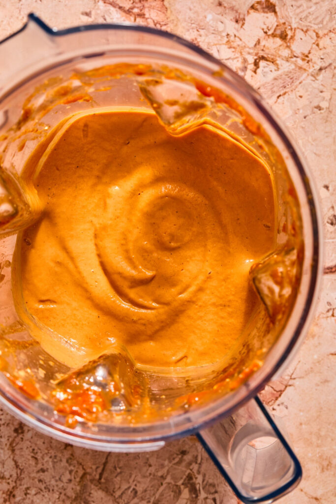 Sauce for Chicken Parmesan Tortellini Bake in a blender bowl.