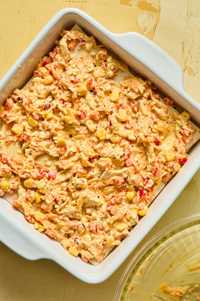 Chicken mixture layered on top of the tortilla halves.
